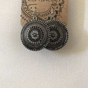 Worn silver medallion earrings